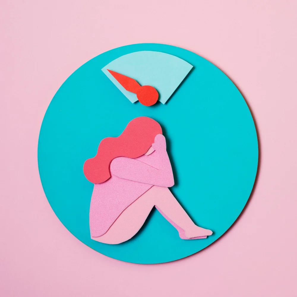 Ilustración en papel recortado de una mujer sentada bajo un medidor, sobre un círculo turquesa
